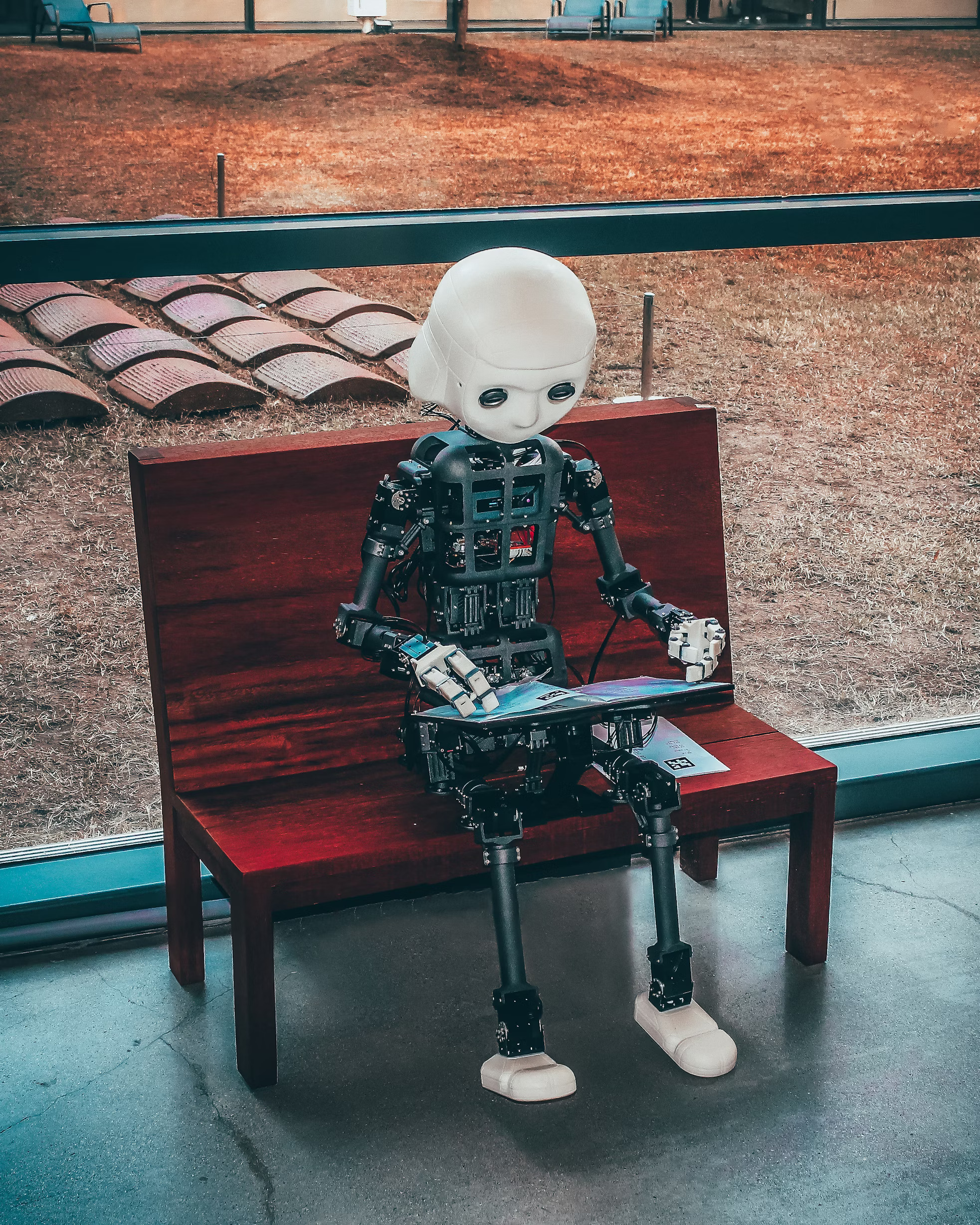 AI robot sitting on a bench